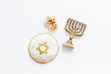 Jewish Holiday Hanukkah With Menorah - Traditional Candelabra, Kippah And Wooden Dreidels Spinning Top. White Background, Top View, Copy Space