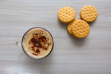 Cappuccino and cookies on a wooden table