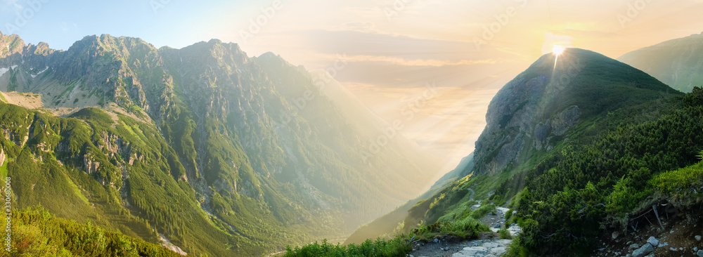 Deep mountain valley in morning sunlight, panoramic view - obrazy, fototapety, plakaty 