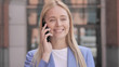 © stockbakers - Young Businesswoman Talking on Phone Outdoor