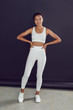 © kanashkin - Young african american woman in white blank leggings and a crop top. Mock-up.