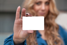 Blonde Beautiful Woman Is Holding An Empty Card In Her Hand