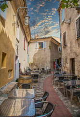 Sticker - Tables outside a restaurant in a narrow Eze alley