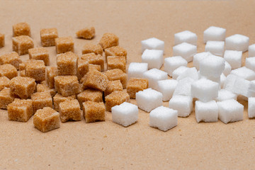 brown and white refined sugar cubes on craft paper background