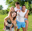 © JackF - Family of four playing in the summer park