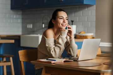 Canvas Print - Happy optimistic woman talking by mobile phone.