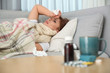 © New Africa - Sick woman lying on sofa at home. Influenza virus