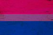 A rustic old bisexual flag on weathered wood