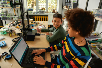 appreciation for innovation. students building and learning to program robot vehicle at a stem robot