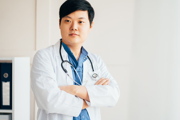 Asian doctor in white coat and uniform at clinic