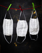 Gauze white medical bandages are dried on a rope with clothespins on a black background