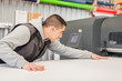 © guruXOX - Technician operator works on large premium industrial printer plotter machine