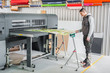 © guruXOX - Technician operator works on large premium industrial printer plotter machine