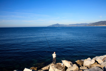 Wall Mural - Sestri Levante (GE), Italy - June 01, 2017: Fisherman in Sestri Levante, Genova, Liguria, Italy