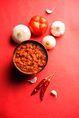 Wall Mural - onion tomato masala or puree for indian gravy, served in a bowl with raw tamatar, pays and lehsun and red chilli, selective focus