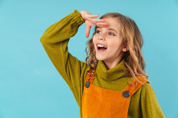 Smiling little girl wearing a dress standing isolated