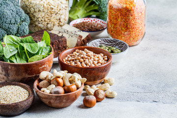 Wall Mural - Vegan sources of protein, background. Tofu, chickpeas, lentils, nuts, spinach and broccoli - vegetable proteins.