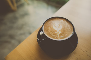 cup of coffee latte art on the cafe table