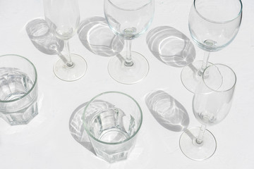 Set of wine and drinking glasses on white background