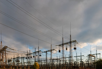 Wall Mural - distribution electric substation with power lines and transformers, at sunset.