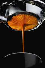 Espresso shot from espresso machine dark background