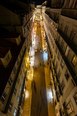 Wall Mural - View of lit buildings and people on the Rua do Carmo street at the Baixa district in Lisbon, Portugal, from above at night.