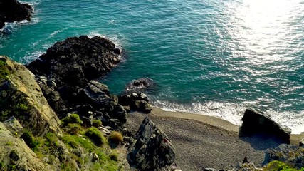 Wall Mural - Peoples runnig in the sand beach. 4K movie top view footage while turquoise waves breaking on a sandy coastline beach