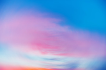 Wall Mural - beautiful backdrop of sunset sky with pink orange light clouds in blue sky. colorful smooth dawn sky