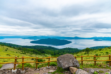 Lake Kussharo in summer season sunny day. Natural landscape from Bihoro-toge pass lookout view point. Akan Mashu National Park, Hokkaido, Japan