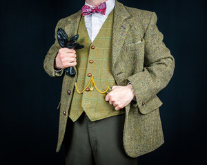 Wall Mural - Portrait of Successful Businessman in Vintage Tweed Suit Holding Leather Gloves. Retro Sartorial Excellence. Stylish English Gentleman. Feel the Need for Tweed. 