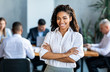 © Prostock-studio - Black Businesswoman Smiling At Camera Posing Standing In Modern Office