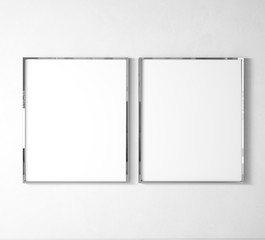 Stylish elegant Vertical metal frame mock up. Double silver frame posters on white wall and floor. 3D illustrations.