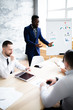 © DmitryStock - A black man in a blue jacket talks about a new strategy for the development and promotion of a marketing plan