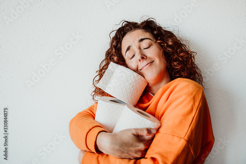 Cuadros en Lienzo .Young woman hoarding a lot of toilet paper at home. Madness caused by the coron