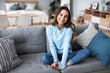 © BestForYou - Beautiful woman relaxing on sofa at home.
