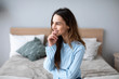 © BestForYou - Carefree woman relaxing sitting on a sofa at home.