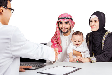 Wall Mural - Muslim family shaking hands with a doctor