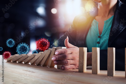 Fotografía Businesswoman stops a chain fall by viruses like domino game