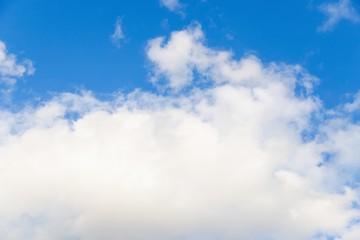 Wall Mural - Beautiful white big soft fluffy cloud on a clear blue sky background