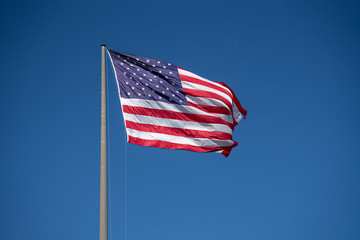 American flag waving in blue sky. Memorial Day