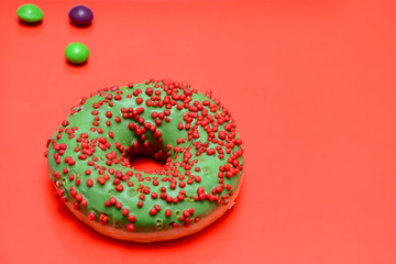 donut with sprinkles on a red background 