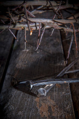 Wall Mural - Bloody nails and crown of thorns as symbol of passion of Jesus Christ. Selective focus.