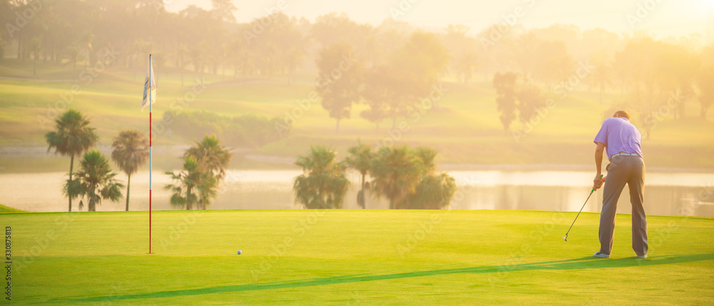 Golfers putting golf balls on the green amid the warm sunshine in the morning. Concept of Outdoor activities and Outdoor sports, Concept of Golfer and Lifestyle. - obrazy, fototapety, plakaty 