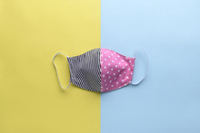 Colorful Pink And Black Fashion Face Mask Handmade From Fabric Cloth On Blue And Yellow Background