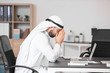 © Pixel-Shot - Arab businessman praying in office