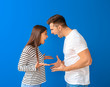 © Pixel-Shot - Young couple quarreling on color background