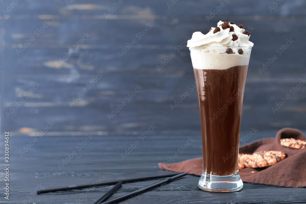 Glass of tasty iced coffee on table
