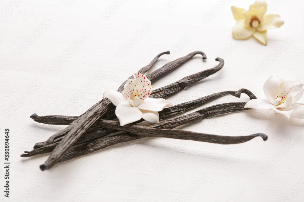 Aromatic vanilla sticks on white wooden background
