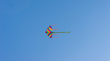 Colorful kite with blue sky background.