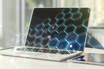 double exposure of technology hologram with hexagon on laptop background. research and development s